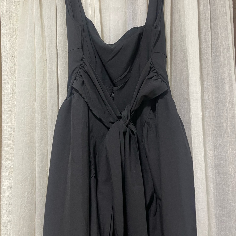 Open back black mini dress with a bow